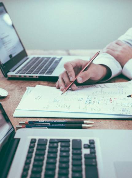 Photo by Scott Graham person holding pencil near laptop computer